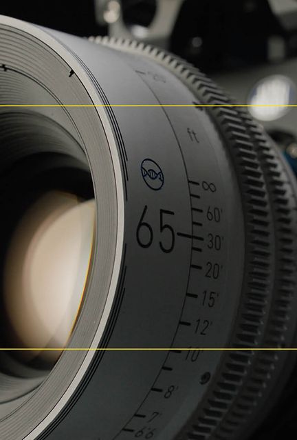 An image of a 65mm lens on a camera; framing guides layer on top.