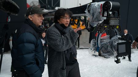 Behind the scenes of “Mickey 17”: Cinematographer Darius Khondji AFC, ASC with director Bong Joon Ho on the set of "Mickey 17." 