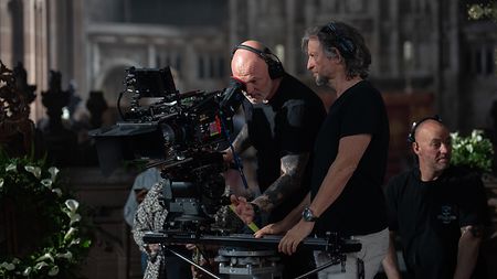 Behind the scenes of “House of Guinness”: Cinematographer Nicolaj Brüel DFF (right) and A-camera operator Karsten Jacobsen (left) discuss a shot on location using a 60 mm ALFA. Behind them is key grip Craig Atkinson.
