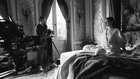 Poor Things Behind the Scenes with Emma Stone Black and White picture on bed 